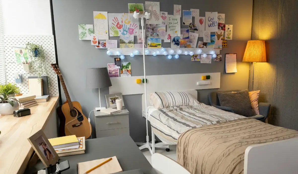 A Personalised Student Bedroom in London With Study Desk Shelving and Guitar.webp